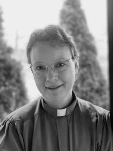 black and white headshot of Leah Schade wearing clerical collar