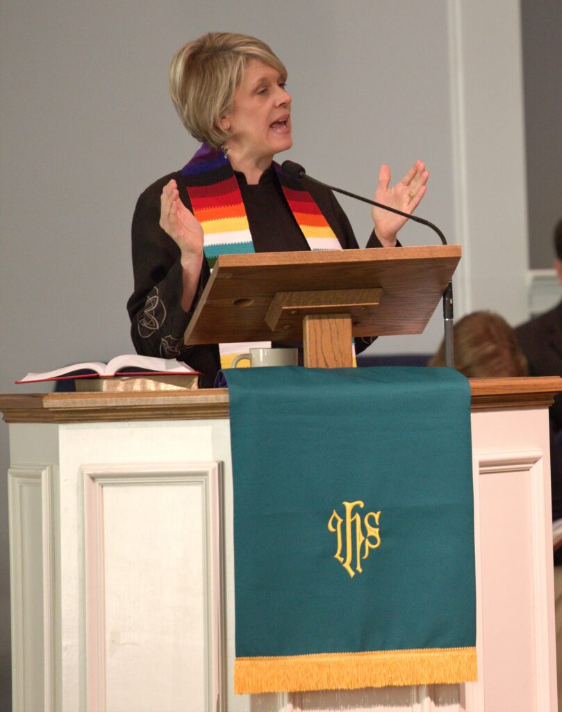 Female Clergy Preaching from a Pulpit in a church