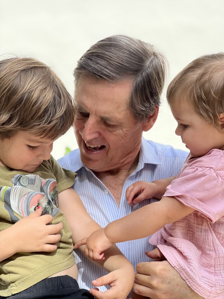Middle-aged white grandfather with 2 grandchildren