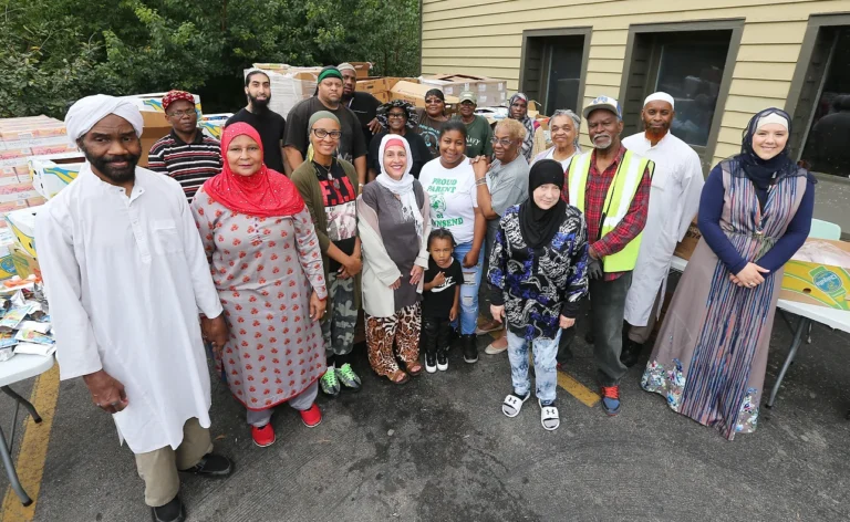 Members posing for a picture outside a food drive.